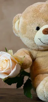 Cute teddy bear with a rose resting gently on wooden surface.