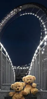 Teddy bears sitting on illuminated bridge at night.