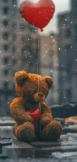 Teddy bear holding a red balloon.