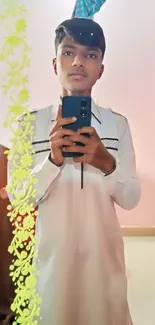 Teen taking a mirror selfie in white casual attire.