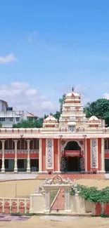 Temple under a vivid blue sky with lush greenery.