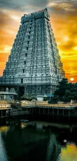 Temple reflecting in water at sunset with orange skies.