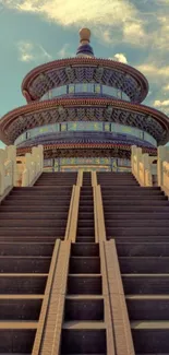 Majestic temple with stairs under a vibrant sky.