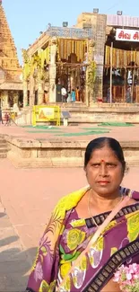 Woman in colorful attire visiting a historic temple site.