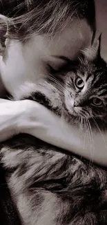 A person hugging a fluffy cat closely.