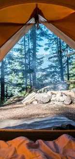 View from a tent with a scenic forest landscape and clear sky.