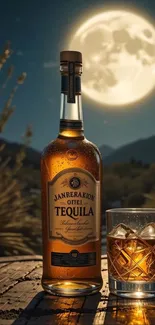 Tequila bottle and glass under a full moon at night.