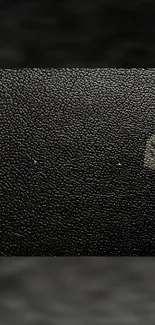 Textured black wallpaper with subtle shadow for mobile phones.