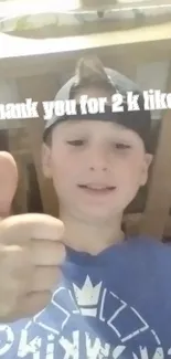 Boy with thumbs-up, thank you for 2k likes text.