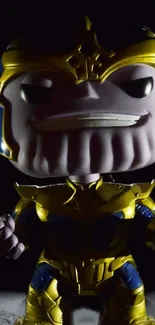 Thanos Funko Pop figure in gold armor on dark background.