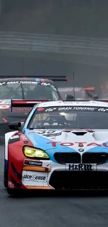 Race cars speeding on a wet track under challenging conditions at a race event.