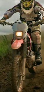 Dirt bike rider navigating muddy trail.