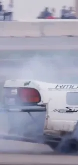 High-speed car drifting on race track, surrounded by smoke.