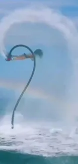 Person flyboarding over the ocean with a rainbow arc in the background.