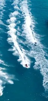 Jet skis racing across vibrant blue water.