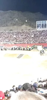 Monster truck show with thrilling stunts and a packed crowd at night.