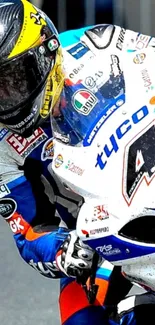 Exciting motorcycle racing with rider in blue and white gear on track.