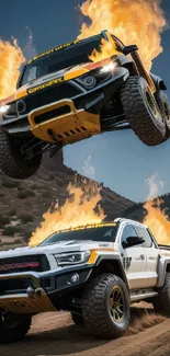 Dramatic off-road trucks jumping with fire in the background.