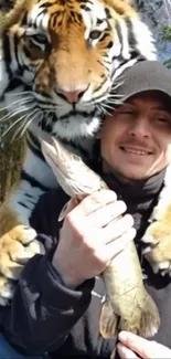 A man and tiger sharing a unique bond outdoors.