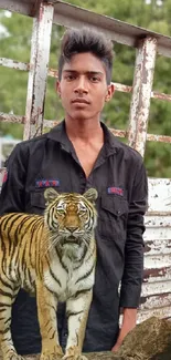 Young man with a tiger in a rustic setting background wallpaper.