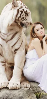 White tiger and woman sitting on rocks in nature.