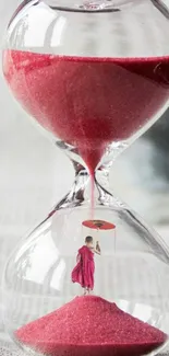 A monk stands inside a glass hourglass with red sand flowing around.