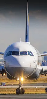 Airplane taxiing on the runway under a clear sky in an aviation-themed wallpaper.