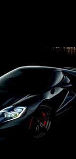 Sleek and elegant black sports car at night.