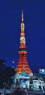 Tokyo Tower illuminated against a dark night sky with glowing city lights.