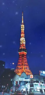 Tokyo Tower illuminated under a starry night sky, showcasing vibrant city lights.