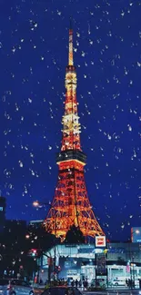 Tokyo Tower illuminated at night against a blue sky with raindrops.