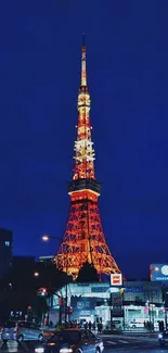 Tokyo Tower lit up against night sky.