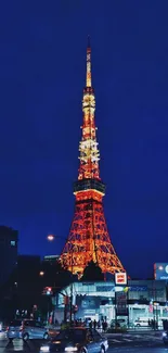 Tokyo Tower illuminated at night against a dark city skyline.