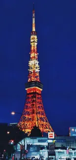 Tokyo Tower brightly lit against night sky.