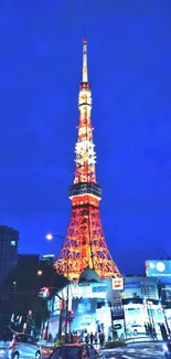 Night view of illuminated Tokyo Tower against a deep blue sky.