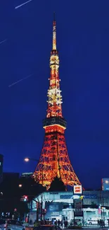 Tokyo Tower glowing at night against a deep blue sky.