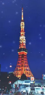 Tokyo Tower illuminated against a dark blue night sky filled with stars.