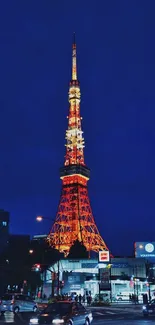 Tokyo Tower glowing at night against a dark blue sky with city lights.