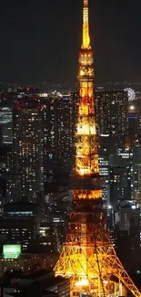 Tokyo Tower lit up in a cityscape at night.