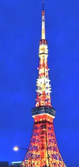 Vibrant night view of Tokyo Tower with a backdrop of city lights.