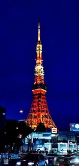 Tokyo Tower and Audi at night in a vibrant cityscape.