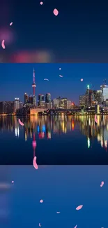 Toronto skyline at night with city lights reflecting on the lake.