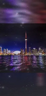 Toronto skyline at night with city lights and reflections on water.