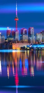 Toronto skyline illuminated at night with city reflections.