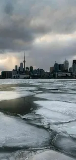 Toronto skyline with ice and cloudy sky.