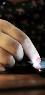 Close-up of a hand touching a glowing smartphone screen.