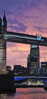 Tower Bridge silhouetted against a vibrant sunset over London's skyline.