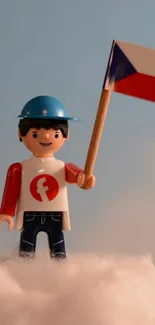 Toy figure holds Czech flag in clouds.