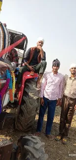 People standing by a colorful tractor in a field.