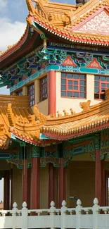 Vibrant Asian temple with intricate roof and colorful art.